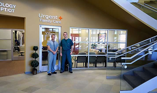 Two men standing in front of a waiting room.