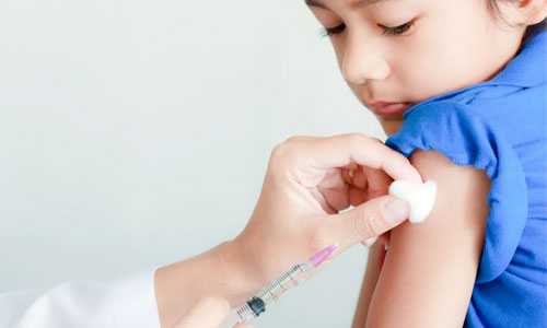 A child getting an injection from a nurse.